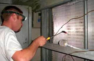 One of our technicians repairing an HVAC unit