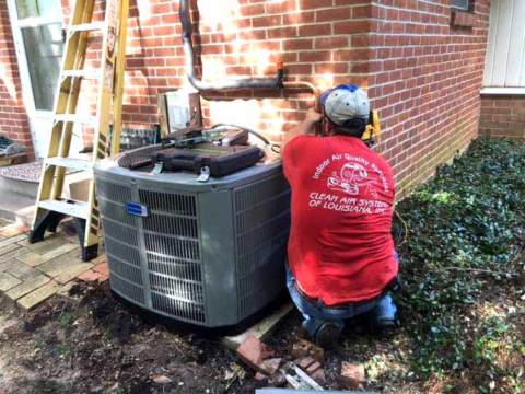 A Clean Air Systems service tech working hard on a customer's HVAC unit.